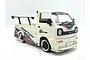 A white WPL D14S Suzuki Carry RC drift truck with a wide body kit, rear spoiler, and custom decals on a white background.