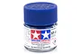 A small glass jar of Tamiya XF-8 Flat Blue acrylic model paint with a blue plastic screw-top lid on a white background.