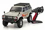 Kyosho 1/10 scale Toyota Land Cruiser 60 Series RC rock crawler in beige with a black roof rack and matching Syncro radio transmitter.