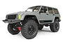 Axial SCX10 II 2000 Jeep Cherokee RC rock crawler in grey, featuring black wheels, off-road tires, and detailed exterior trim on a white background.