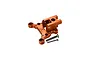 An orange anodized aluminium centre differential mount by GPM Racing, shown with two included steel screws against a white background.