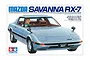 Tamiya 1/24 scale Mazda Savanna RX-7 plastic model kit box art featuring an illustration of a light blue RX-7 with a driver.