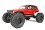 A red Axial Wraith Spawn 1/10 scale RC rock racer truck with large off-road tires and a driver figure visible inside the cabin.