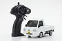 A white Kyosho First Mini-Z Subaru Sambar RC truck with its black pistol-grip remote controller on a white background.