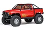 A red Axial SCX10 III 1987 Toyota SR5 RC rock crawler truck with a black roll cage and off-road tires, shown against a white background.