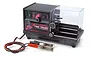A Hudy professional fully automatic RC tyre truer machine with a black casing, clear protective cover, and power leads with alligator clips.