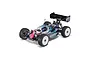 A studio shot of the Kyosho Inferno MP11 1/8 scale nitro RC buggy, featuring a painted body with pink and blue accents, white wheels, and a rear wing.