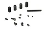 A collection of various sizes of black metal grub screws scattered on a white background.