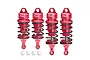 Four red GPM Racing adjustable aluminium RC shock absorbers with black springs and four white plastic ball ends on a white background.