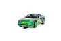 A 1/32 scale Scalextric Mazda RX-7 FD slot car in green and silver livery with number 7, displayed on a section of black slot car track.