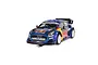 A 1/32 scale Scalextric Ford Puma WRC slot car in blue and yellow Red Bull livery on a white background.