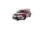 A 1/32 scale Scalextric Toyota Supra MK4 slot car in red and silver racing livery with number 80, shown on a track section.