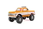 Axial SCX24 1/24 scale 1967 Chevrolet C10 RC rock crawler truck in orange and white, featuring a chrome roll bar with off-road lights.