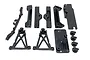 A set of black plastic RC chassis braces and body mounts from Reefs RC, including various structural components and four branded body post knobs.