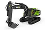 A Huina 1/18 scale RC excavator in black and lime green, featuring a detailed cab, articulated arm, and rubber tracks on a white background.