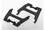 Two black plastic Traxxas battery hold-down brackets for RC vehicles, shown from a high-angle studio perspective.