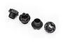 Four black plastic wheel nuts for Traxxas RC vehicles arranged on a white background.