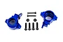 Two blue anodized aluminium steering hubs for Traxxas RC vehicles, accompanied by a set of black steel screws and nuts on a white background.