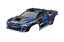 Traxxas 1/6 XRT Ultimate clipless painted body shell in blue and black with graphic details, isolated on a white background.