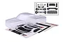 Unpainted clear Traxxas Ford Raptor RC truck body shell with included black plastic trim parts and decal sheet on a white background.