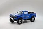 Kyosho Outlaw Rampage Pro 2.0 RC trophy truck in blue with white racing stripes, featuring off-road tires and a roll cage on a white background.