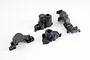 Four black plastic gearbox case components for an FMS RC vehicle arranged on a white background.