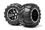 Two black RC monster truck wheels with aggressive tread patterns and five-spoke black rims with silver beadlock-style rings.