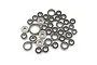 A collection of various sized steel ball bearings scattered on a plain white background.