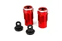 Two red anodized aluminum RC shock bodies and two black plastic shock caps on a white background.