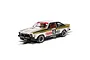 A 1/32 scale Scalextric Holden A9X Torana slot car in white, gold, and black livery with Craven Mild racing decals on a track.