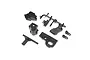 A set of black plastic RC car parts including transmission case halves, a motor mount plate, and linkage components on a white background.