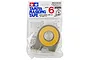 A roll of Tamiya 6mm masking tape in a grey plastic dispenser, sealed in original retail packaging.