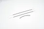 A set of three thin steel wires with black protective sleeves, laid out on a plain white background.