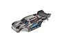 ARRMA Vorteks 1/10 scale RC truck body shell in blue and black with lightning-style graphics, shown from a high-angle studio view.
