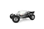 A clear, unpainted Pro-Line Baja Bug body shell mounted on an RC buggy chassis with black off-road tires and chrome wheels against a white background.