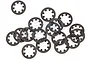 A collection of 15 small, dark grey steel star-shaped locking washers scattered on a white background.