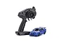 Kyosho Mini-Z Nissan Skyline GT-R R34 RC car in metallic blue next to a black Syncro KT-531P radio transmitter on a white background.