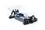 A 1/10 scale LRP Antix S10 Blast BX3 RC buggy chassis with a clear, unpainted polycarbonate body shell and rear wing, shown on a white background.