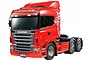 A studio shot of a red Tamiya Scania R620 6x4 Highline RC semi-truck model on a white background.