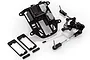 Rovan symmetrical steering conversion kit parts including a black plastic radio box, steering bellcrank assembly, and mounting spacers on a white background.