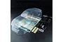 An unpainted clear polycarbonate RC car body shell with included decal sheet, plastic parts tree, and mounting hardware on a black background.