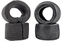 Two black RC buggy tyres with knobby tread patterns and two matching grey foam inserts against a white background.