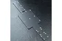 A black FRP main chassis plate for an MST RC car, featuring multiple pre-drilled mounting holes and a flat, rectangular central section.