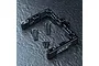 MST aluminium rear battery mount connector in black, including six flat-head screws on a dark textured surface.