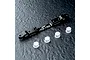 A black MST aluminium adjustable lower suspension arm mount with four small white plastic inserts on a dark textured surface.