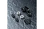 MST aluminium transmission vibration suppressor in black, including two ball bearings and four black countersunk screws on a dark textured surface.