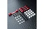 MST red aluminium suspension arm mount set including four metal mounts, screws, plastic spacers, and bushings on a dark textured surface.