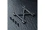 MST black aluminium X-shaped suspension arm mount brace with four matching black screws on a textured dark surface.