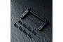 A black aluminium RC servo mount with mounting hardware including screws and washers on a dark textured surface.