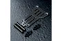 MST carbon fiber rear link plate with two black metal standoffs and eight small black screws on a textured dark surface.